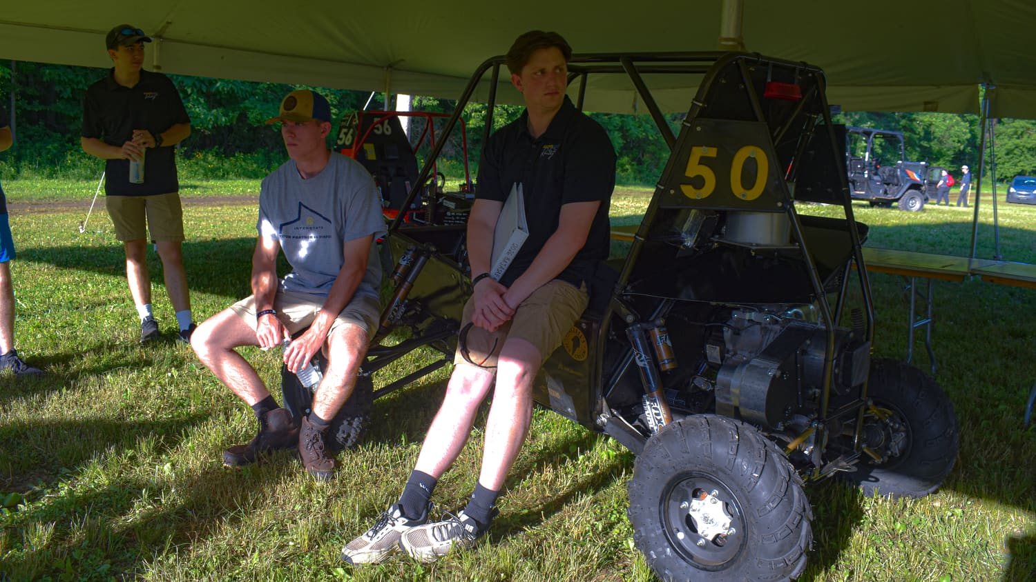 Team members resting beside GBR4 between sessions